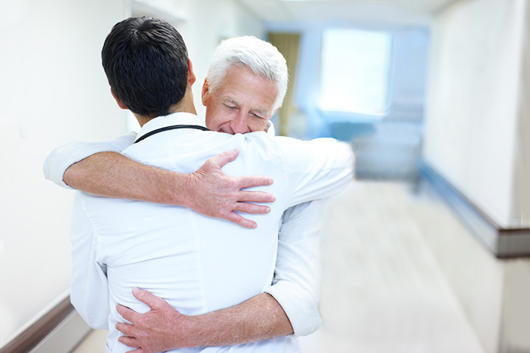 Dr. justin kubeck hugs a patient of theprecision procedure